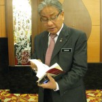 Kuala Pilah MP Datuk Hasan Malek perusing his copy.