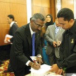 Hulu Selangor MP P Kamalanathan signing for his copy of the book.