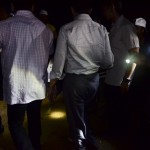 Party workers light the way for Anwar as he walks up to the ceramah spot.