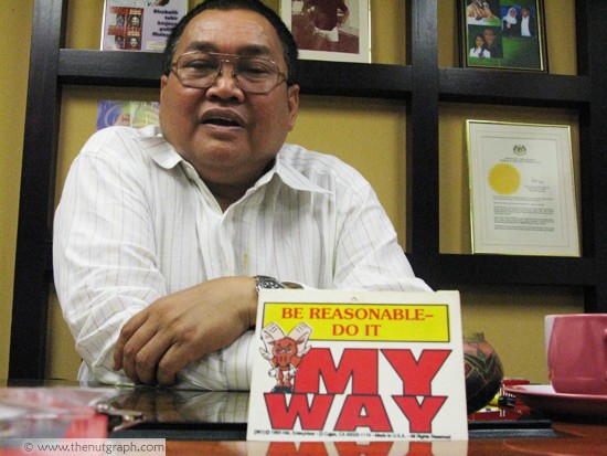  Ibrahim in his office with a sign that says much about his politics 