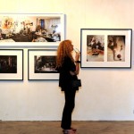 A guest reading the write-up on WORKING. Behind her are photographs of Jalaini at work.