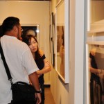 Guests looking at a photograph of Zakii and a male model.