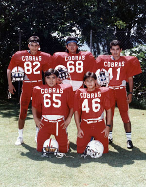 In American football gear in school. From left is Hans, his friend Azrai and brother Carl