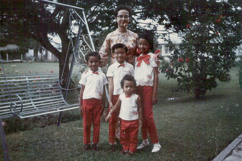 The only daughter and eldest child, Marina poses with her brothers and their mother. 